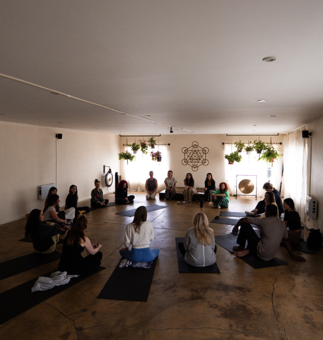 A group seated together in a circle during a guided team session