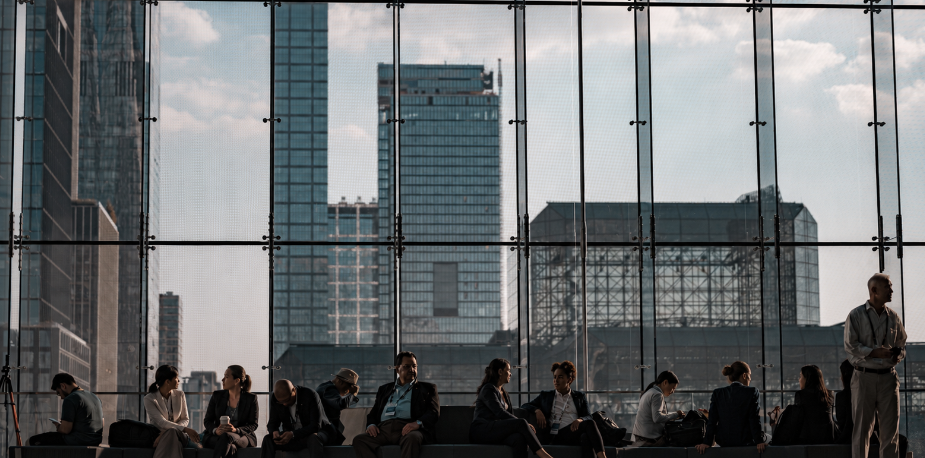 A team gathered in a windowed business space overlooking the city